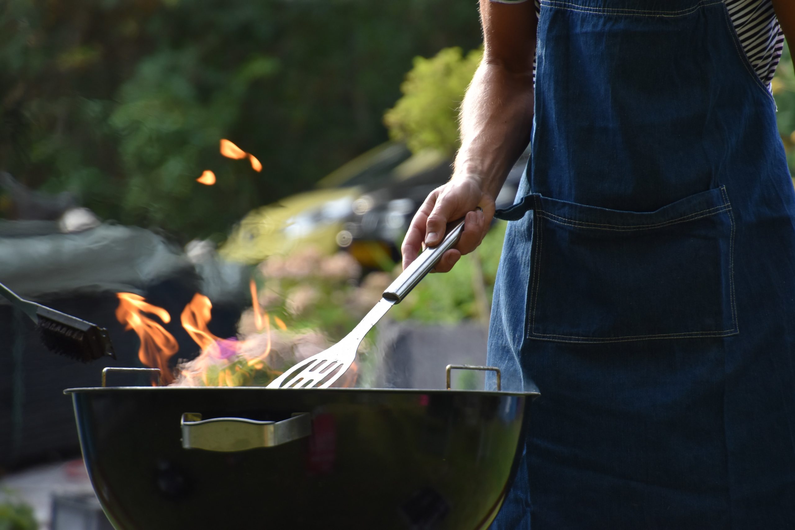 Someone grilling over an open flame grill